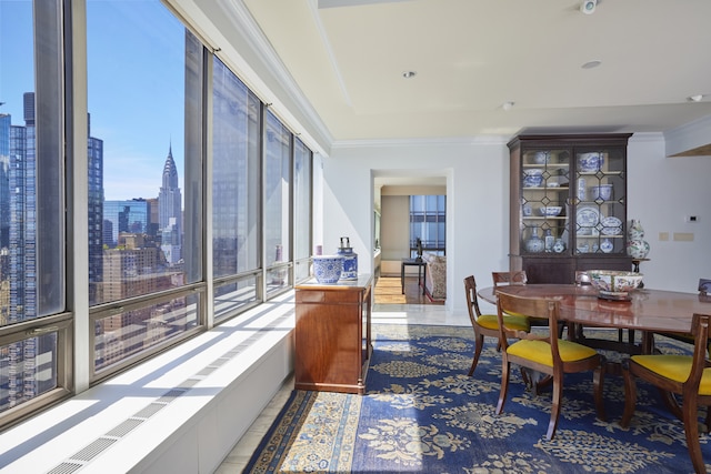 dining space with a city view and crown molding