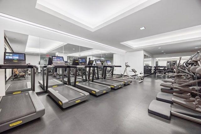 exercise room with a raised ceiling