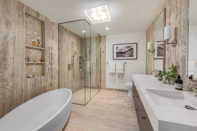 full bathroom with a stall shower, a sink, a freestanding bath, and double vanity