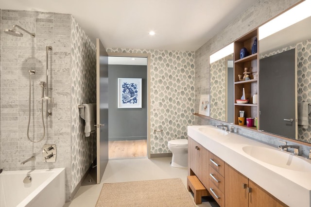 bathroom featuring double vanity, a sink, toilet, and tile patterned floors