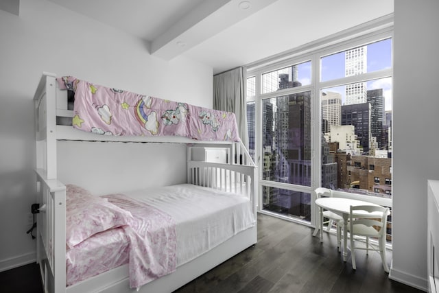 bedroom with dark hardwood / wood-style floors and beamed ceiling