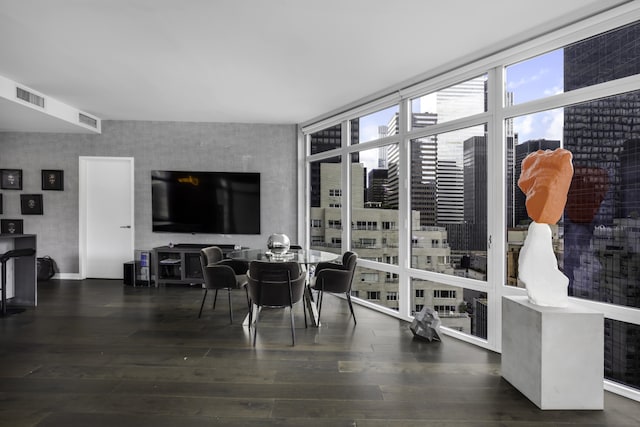 dining room featuring dark wood-style flooring, visible vents, and floor to ceiling windows