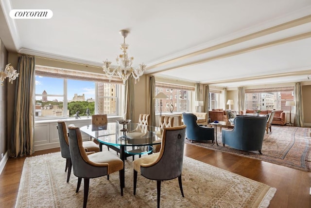 dining area with a notable chandelier, wood-type flooring, and ornamental molding