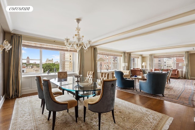 dining room featuring wood finished floors, visible vents, crown molding, and an inviting chandelier