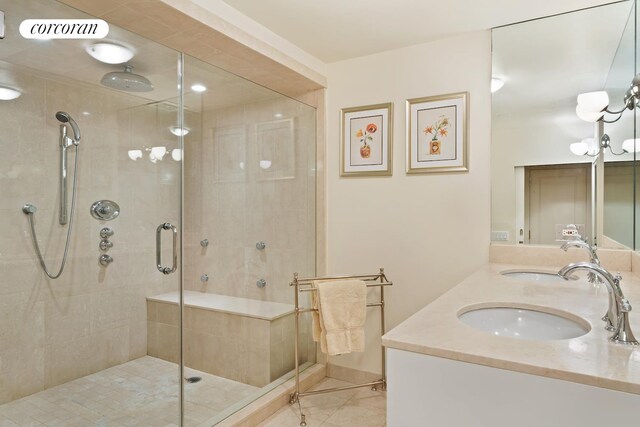 bathroom featuring a stall shower, visible vents, a sink, and double vanity