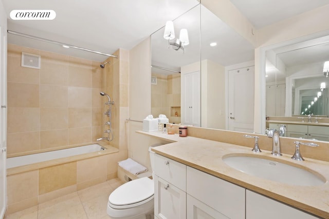 full bath featuring tiled shower / bath, visible vents, toilet, vanity, and tile patterned flooring