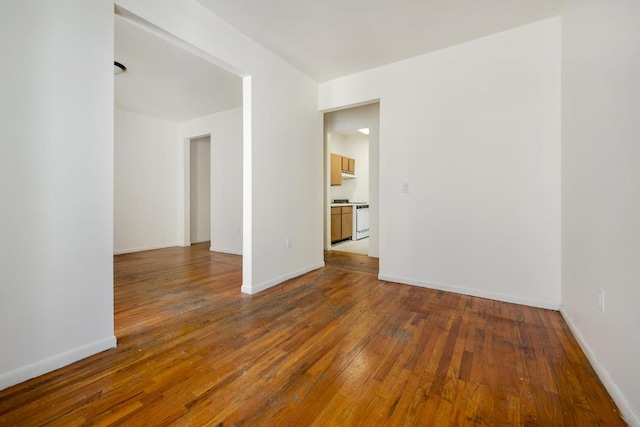 spare room with dark wood-type flooring