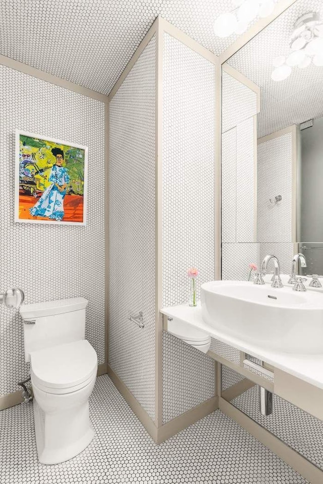 bathroom featuring wallpapered walls, toilet, and tile patterned floors