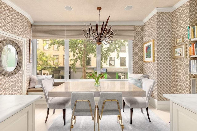 dining area with crown molding, an inviting chandelier, and wallpapered walls