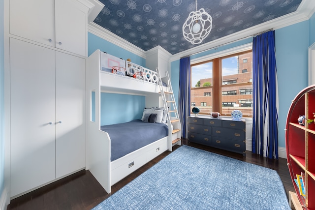 bedroom featuring dark wood-type flooring, baseboards, and crown molding