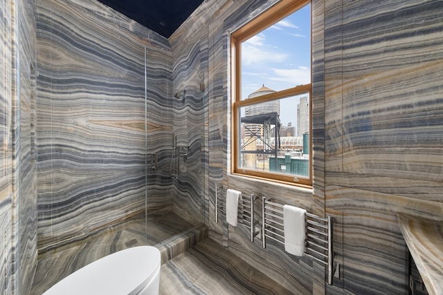bathroom with a view of city, walk in shower, and toilet