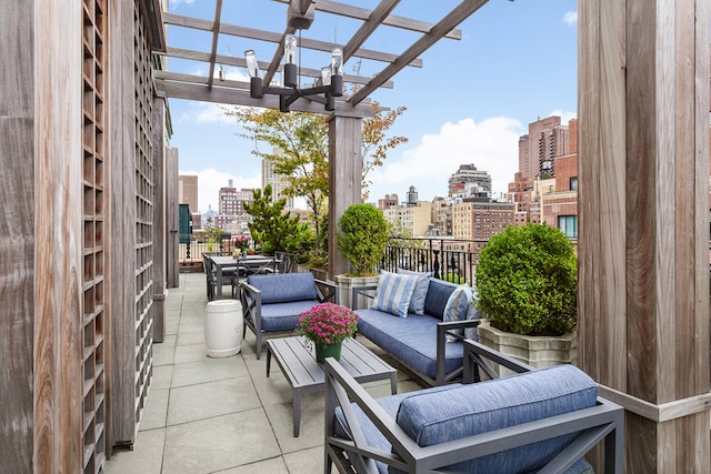 balcony with outdoor lounge area, a view of city, and a pergola