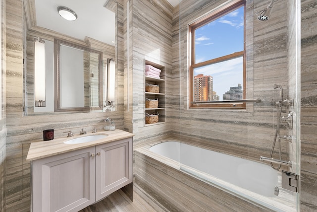 bathroom featuring a shower, vanity, and a tub