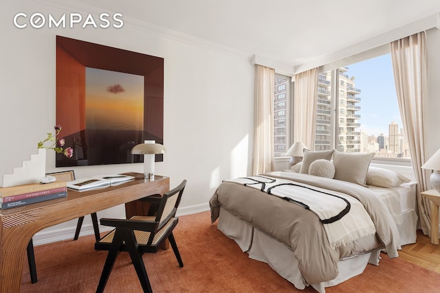 bedroom with crown molding, baseboards, and a view of city