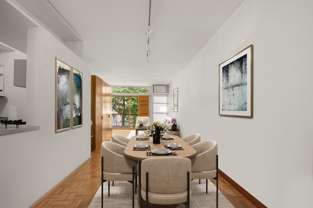 dining area featuring rail lighting