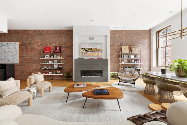55 Warren St Unit 3, New York City, NY 10007 - living room with a glass covered fireplace, wood finished floors, and brick wall