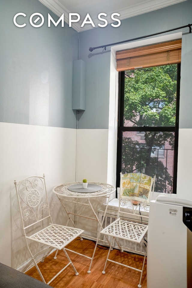 dining room with crown molding and wood finished floors
