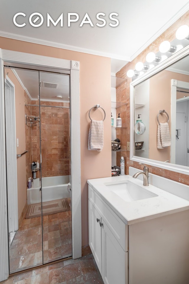 bathroom featuring ornamental molding, stone finish floor, and vanity