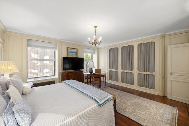 bedroom featuring dark hardwood / wood-style floors and an inviting chandelier