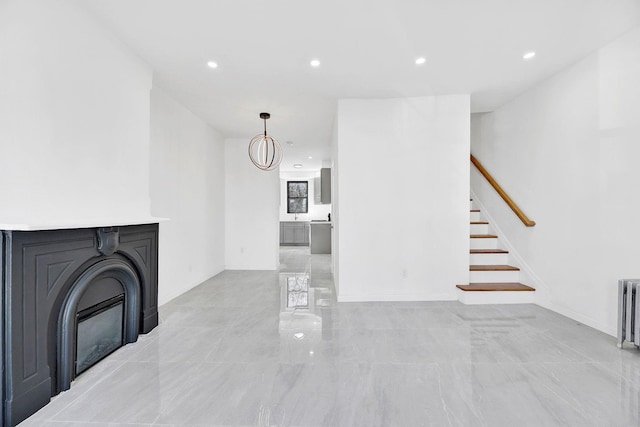 living room with a glass covered fireplace, recessed lighting, stairs, and baseboards