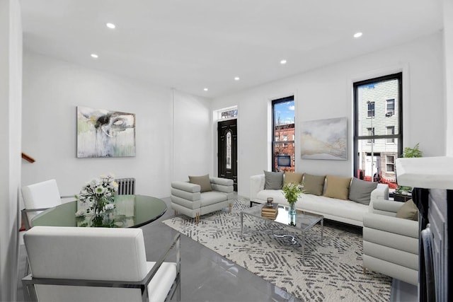 living room with radiator heating unit and concrete floors