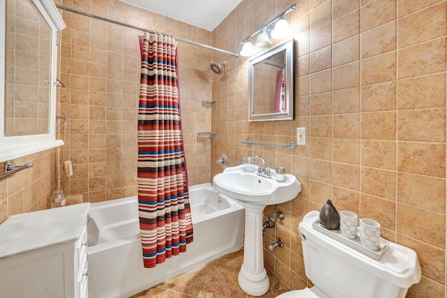 bathroom with toilet, tile walls, and shower / tub combo with curtain