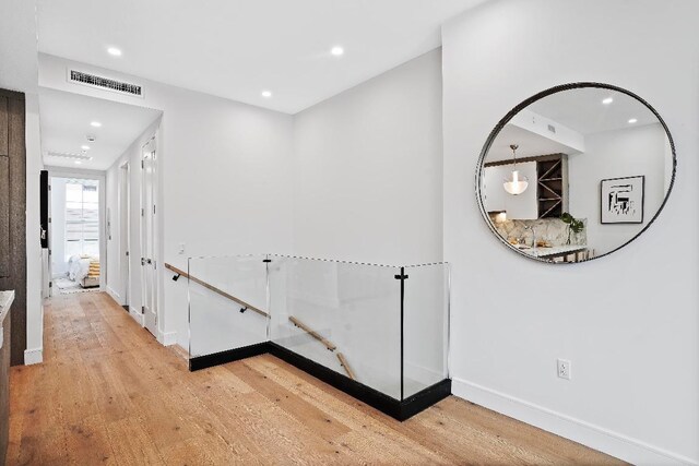 living room featuring light hardwood / wood-style floors and a tray ceiling