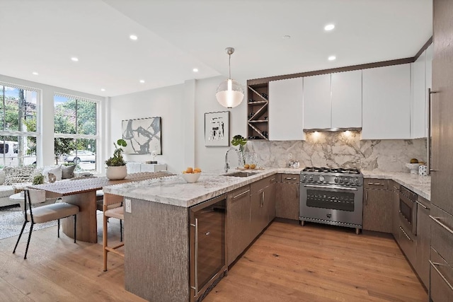 kitchen featuring wine cooler, white cabinetry, decorative light fixtures, kitchen peninsula, and stainless steel appliances