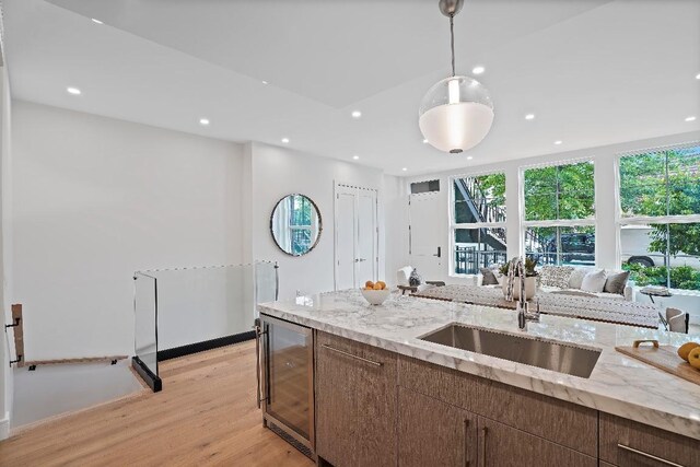 dining room featuring sink and light hardwood / wood-style floors