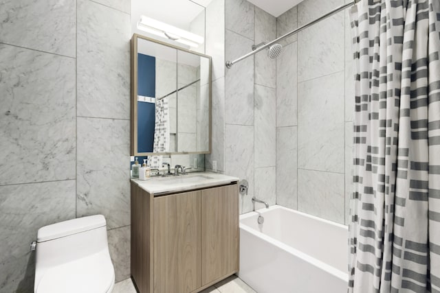 full bathroom featuring shower / bath combo with shower curtain, vanity, toilet, and tile walls