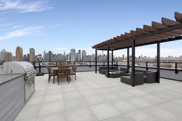 view of patio with area for grilling, a pergola, and exterior kitchen