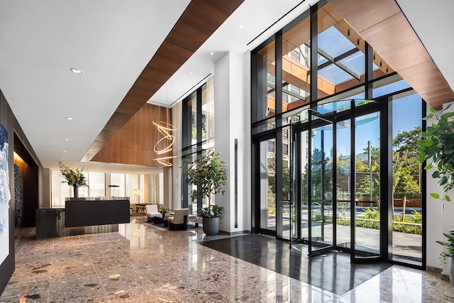building lobby with a towering ceiling and expansive windows