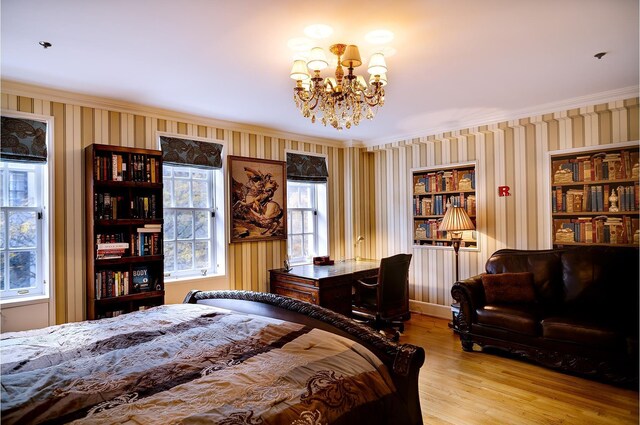 bedroom featuring ornamental molding, a chandelier, and light hardwood / wood-style flooring