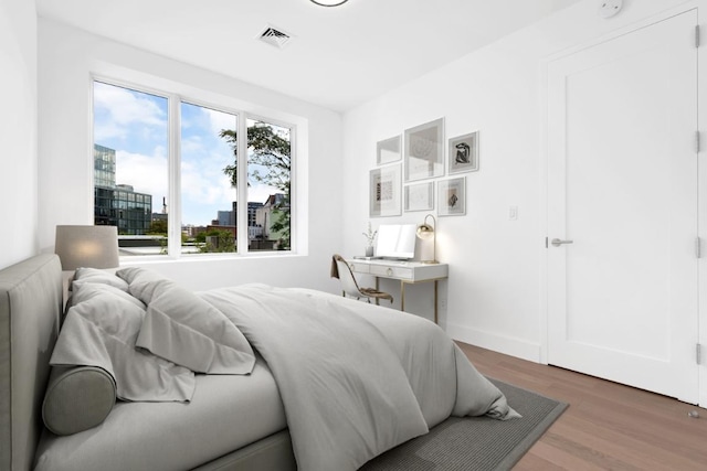 bedroom with dark wood-type flooring