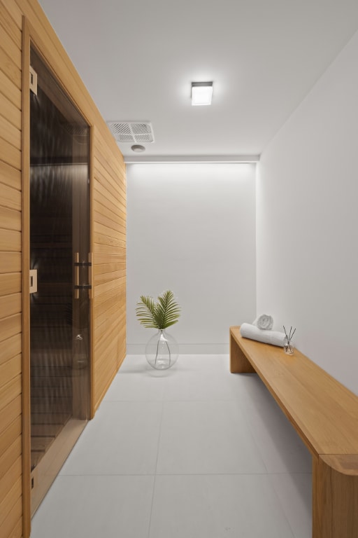 corridor with wooden walls and light tile patterned flooring