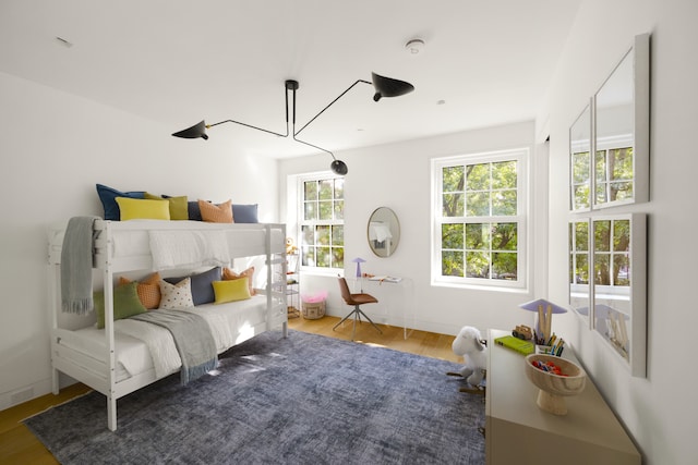 bedroom with baseboards and wood finished floors