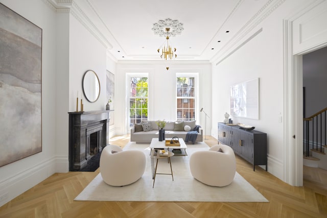 living room featuring crown molding, baseboards, a chandelier, stairway, and a fireplace with flush hearth