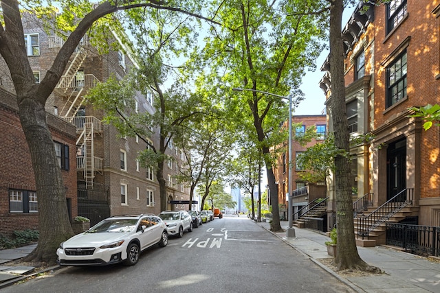 view of road with curbs, sidewalks, and street lighting