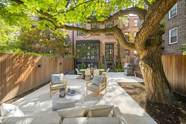 view of patio featuring area for grilling, an outdoor hangout area, and a fenced backyard