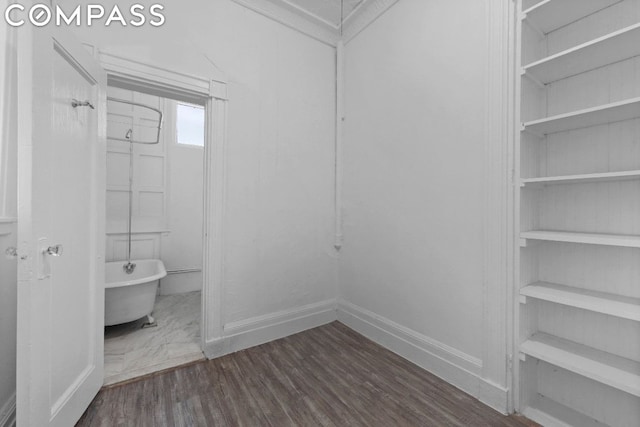 bathroom with a washtub and hardwood / wood-style flooring