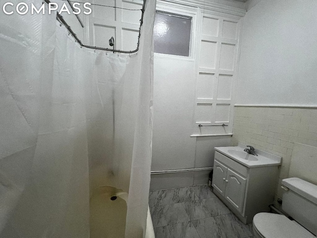 full bathroom with shower / bath combo, toilet, vanity, and tile walls