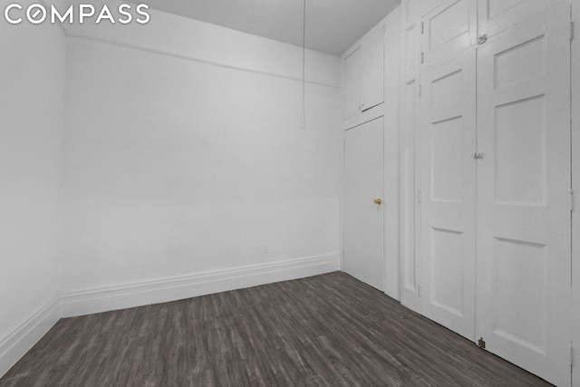 empty room with dark hardwood / wood-style floors