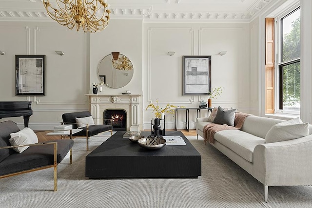 living room with ornamental molding, plenty of natural light, and a chandelier