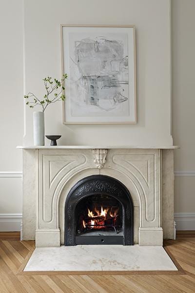 interior details featuring wood finished floors, a fireplace, and baseboards