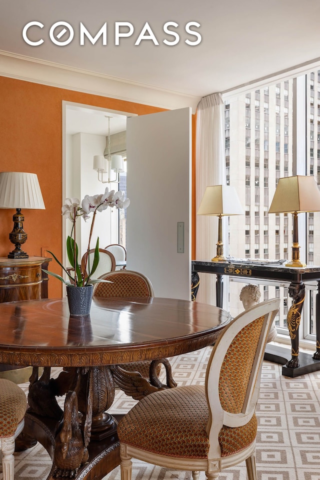 dining space featuring a chandelier and ornamental molding