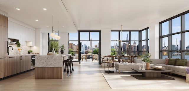 kitchen featuring wall oven, decorative backsplash, modern cabinets, expansive windows, and a view of city