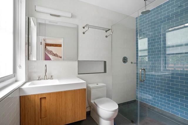 308 E 30th St Unit 1, New York City, NY 10016 - bathroom featuring tile walls, a shower stall, vanity, and backsplash