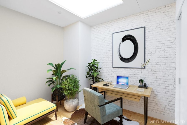 home office featuring hardwood / wood-style flooring and brick wall