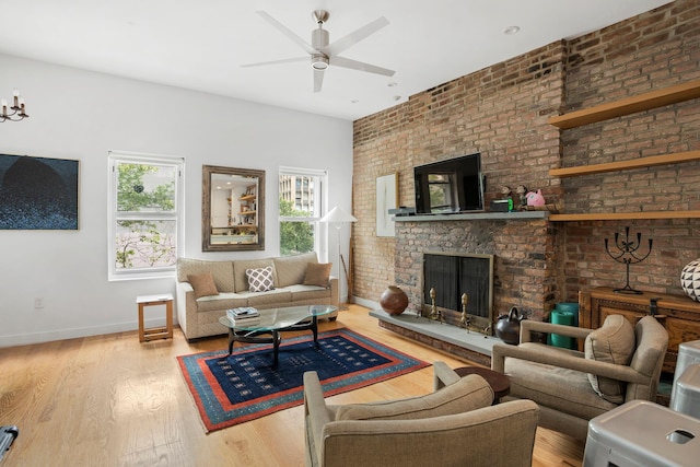 308 E 30th St Unit 1, New York City, NY 10016 - living room featuring wood finished floors, ceiling fan, and a brick fireplace
