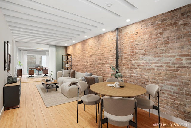 308 E 30th St Unit 1, New York City, NY 10016 - dining room featuring light wood-style flooring and brick wall